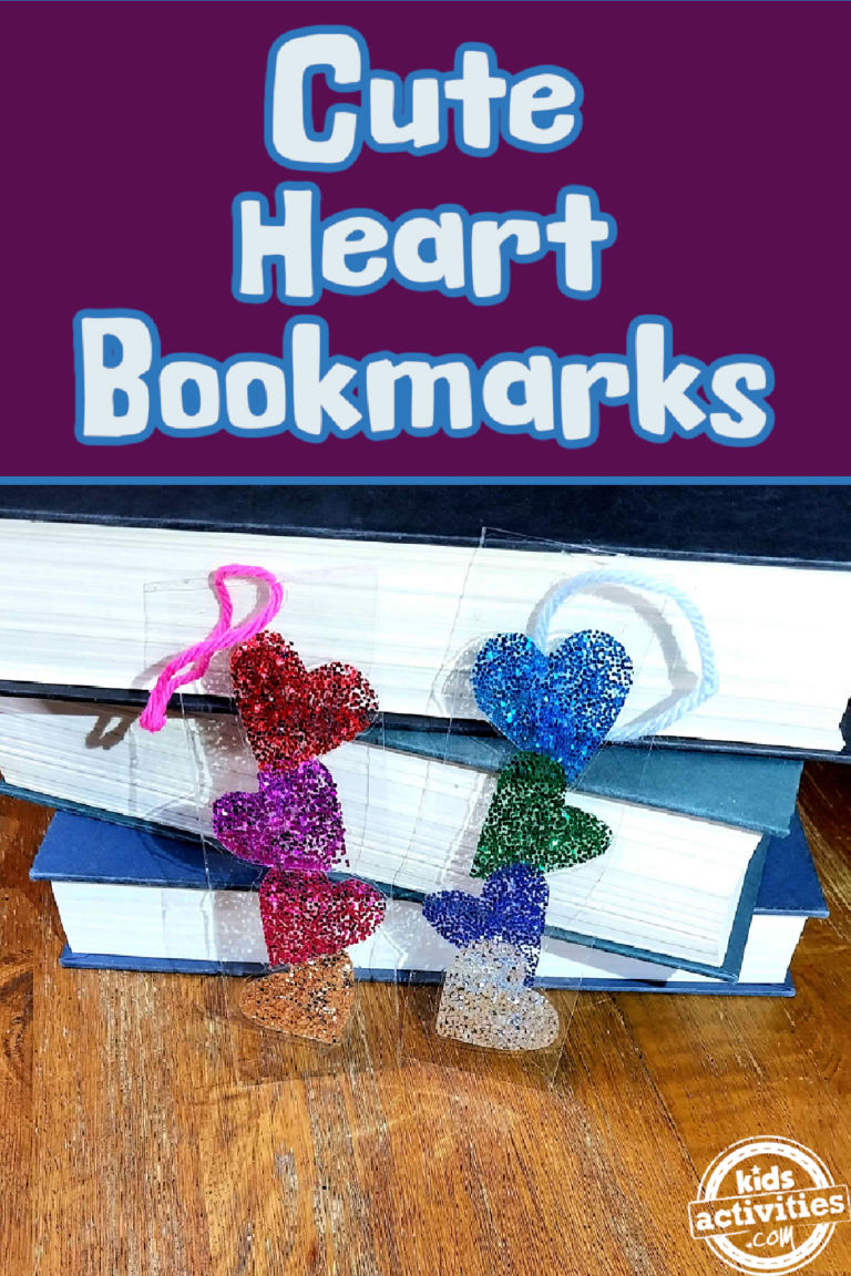 Heart Bookmark- red and pink with gold and blue green and silver bookmarks on a wood table up against 3 blue books- kids activities blog