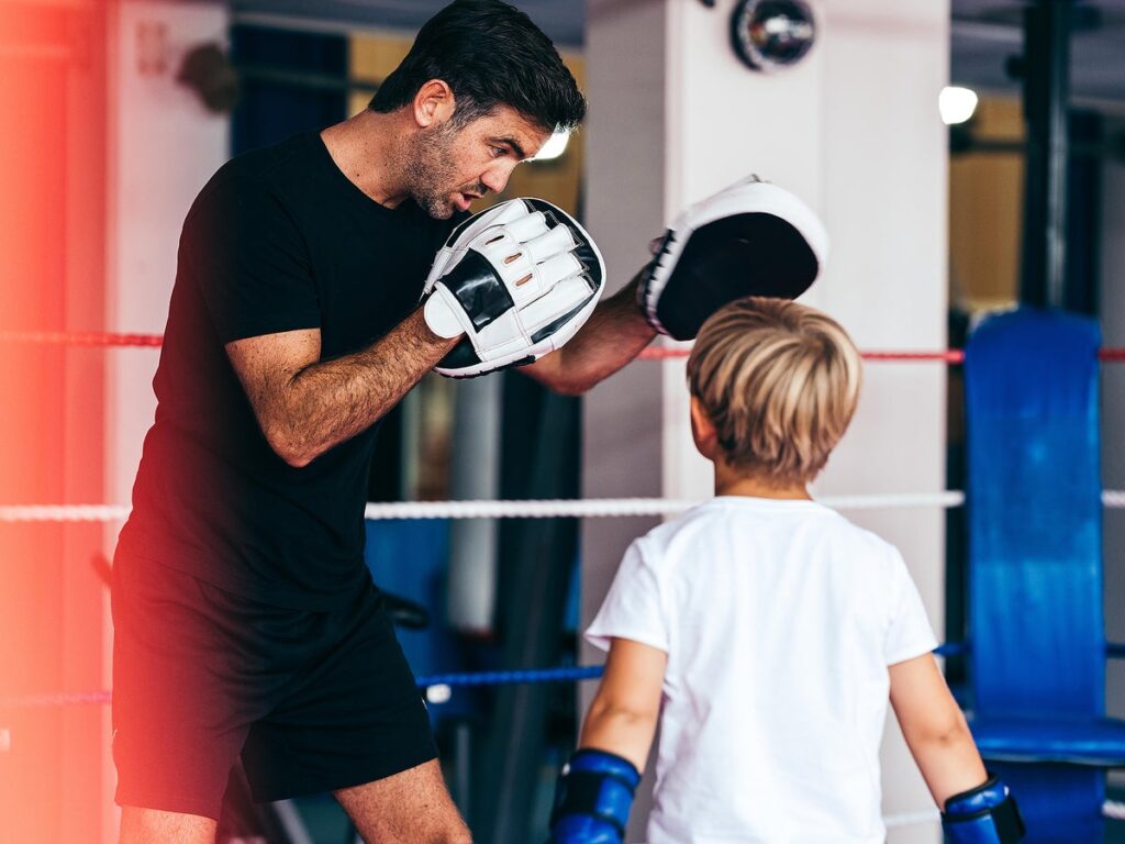 Boxing coach with student